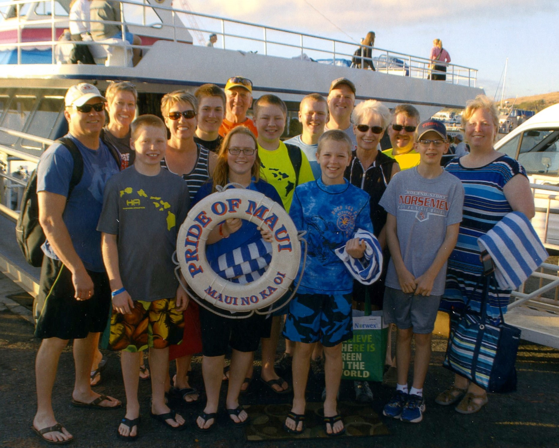 family picture in front of the whale watching boat